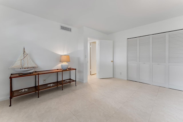 bedroom featuring a closet and light tile patterned floors