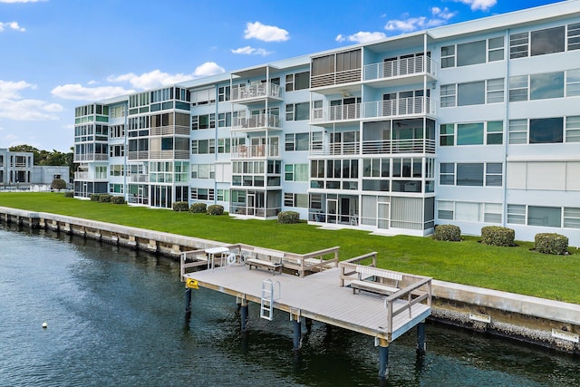 dock area featuring a lawn and a water view