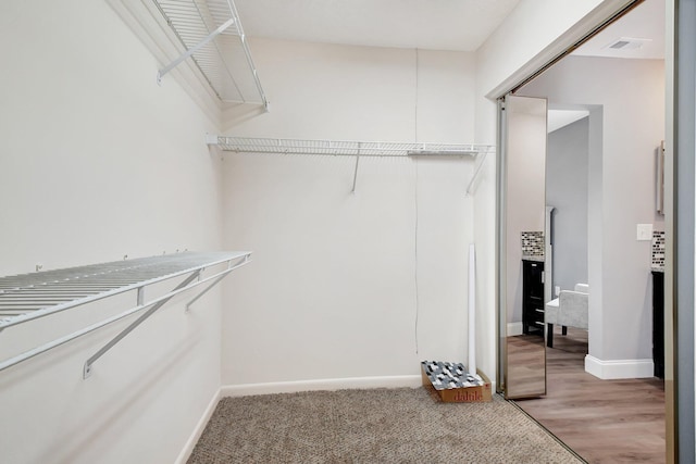 spacious closet with light hardwood / wood-style floors