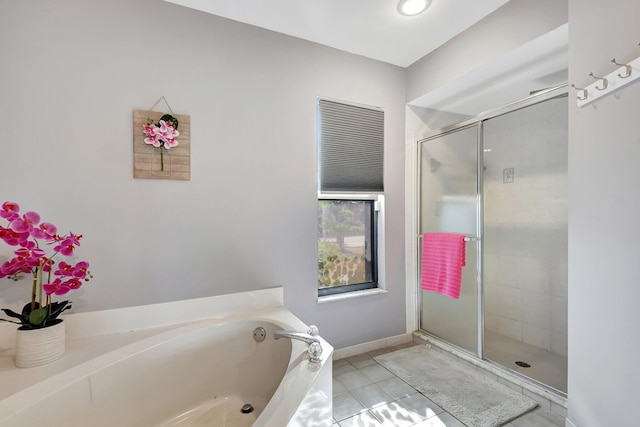 bathroom with tile patterned flooring and separate shower and tub