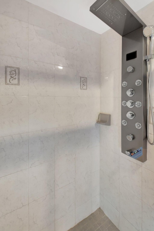 bathroom with a tile shower