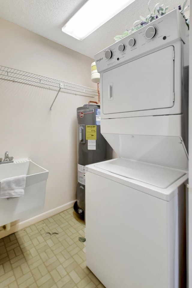 laundry room with water heater, sink, and stacked washer and clothes dryer