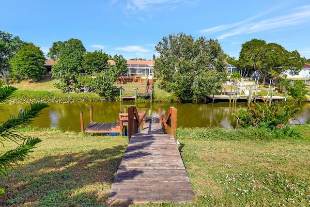 view of dock featuring a yard and a water view