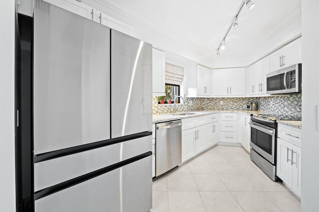 kitchen featuring white cabinets, stainless steel appliances, ornamental molding, and sink