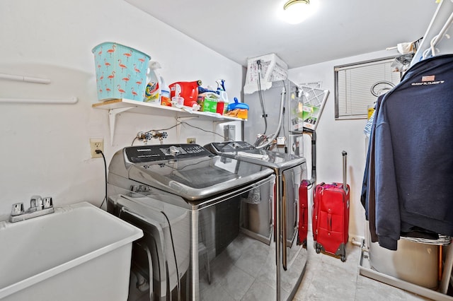 laundry room with washing machine and dryer and sink