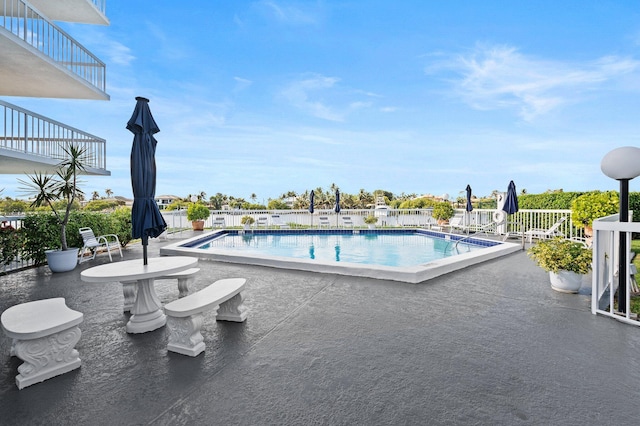 view of swimming pool with a patio