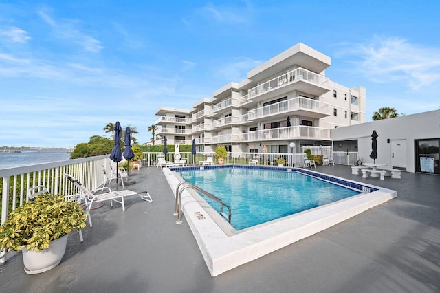 view of pool with a water view