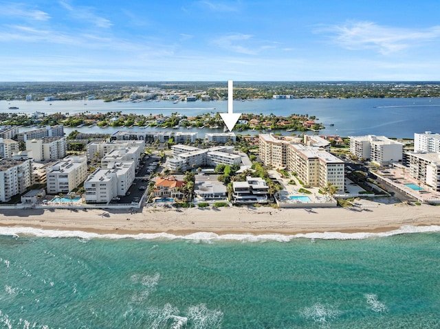 birds eye view of property with a view of the beach and a water view