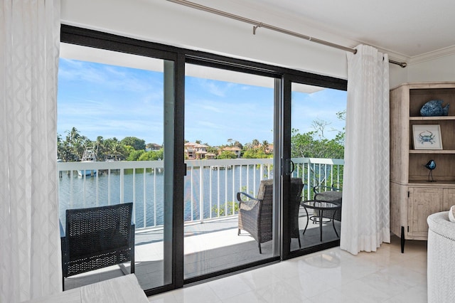 entryway featuring a water view, plenty of natural light, and ornamental molding