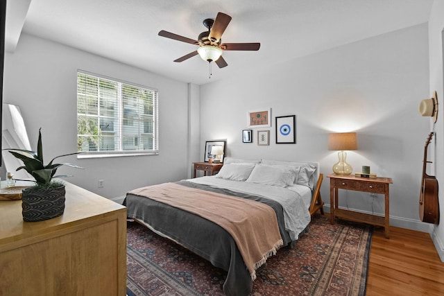 bedroom with ceiling fan and hardwood / wood-style flooring