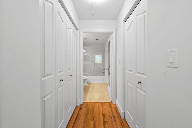 hall with light hardwood / wood-style floors