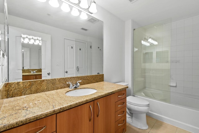 full bathroom with tile patterned flooring, vanity, toilet, and tiled shower / bath