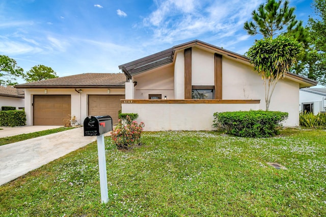 view of property exterior featuring an attached garage, a yard, driveway, and stucco siding