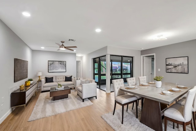 dining area with ceiling fan and light hardwood / wood-style floors