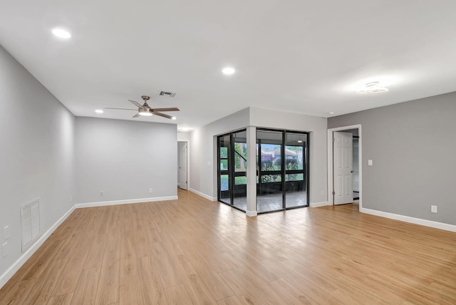 empty room featuring ceiling fan and light hardwood / wood-style floors