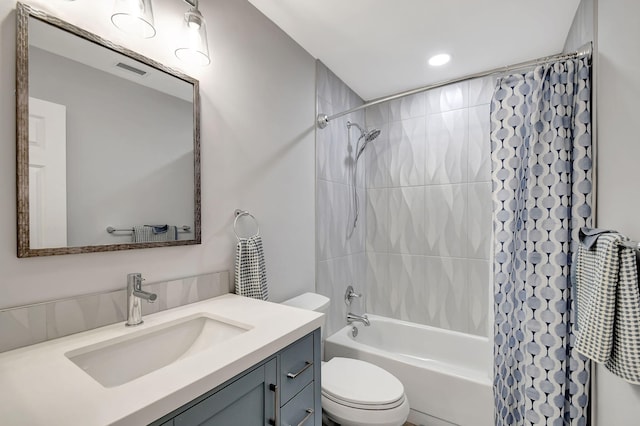 full bathroom with vanity, toilet, and shower / tub combo