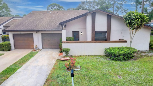 view of front of house featuring a garage and a front lawn