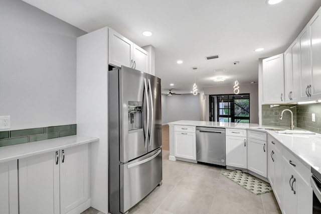 kitchen featuring white cabinets, stainless steel appliances, and kitchen peninsula