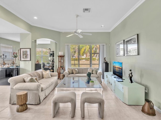 tiled living room with ceiling fan and ornamental molding