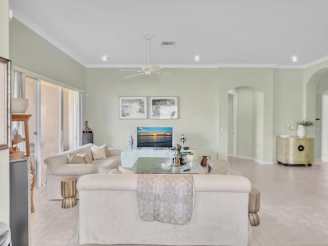 living room with ceiling fan and crown molding