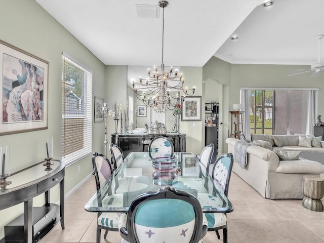 dining space with crown molding, light tile patterned floors, a healthy amount of sunlight, and ceiling fan with notable chandelier