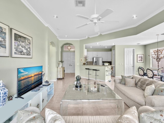 living room with light tile patterned floors, ceiling fan, and crown molding