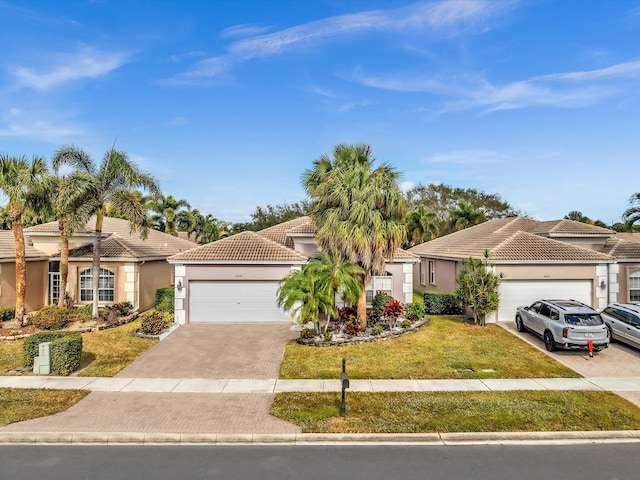 mediterranean / spanish-style house featuring a garage and a front lawn