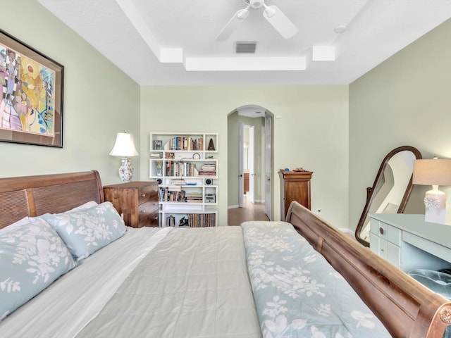 bedroom featuring ceiling fan and a raised ceiling