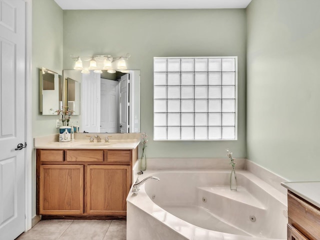 bathroom featuring vanity, tile patterned floors, and tiled tub