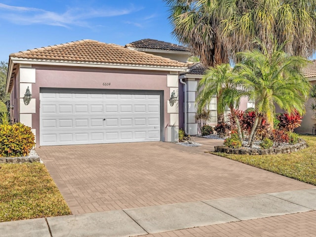 mediterranean / spanish-style home with a garage