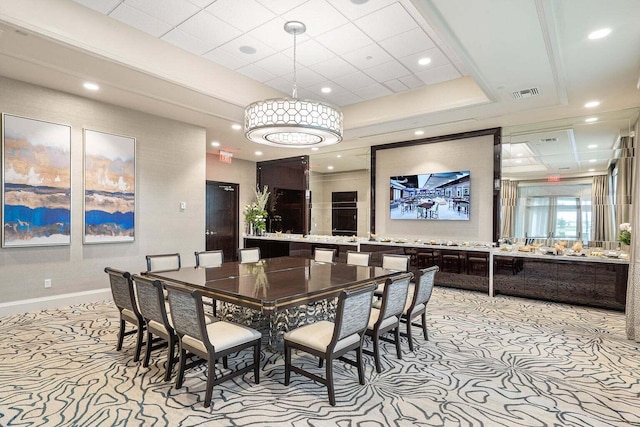 carpeted dining space featuring a raised ceiling