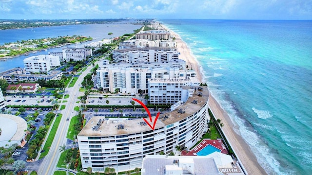 drone / aerial view featuring a water view and a beach view