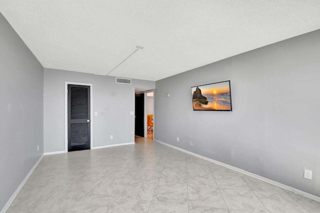 empty room with a textured ceiling