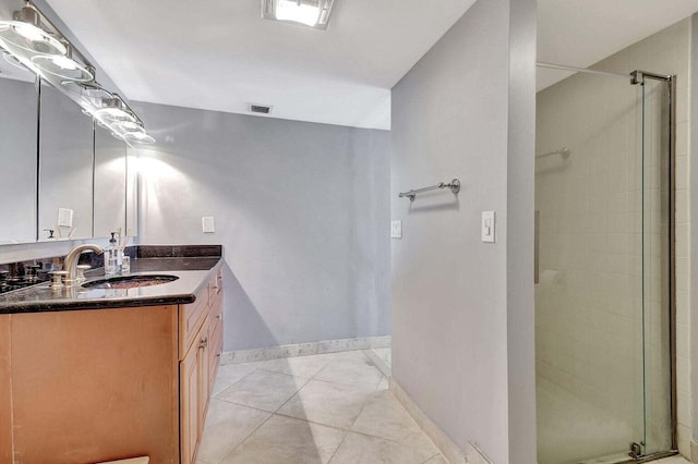 bathroom featuring tile patterned floors, vanity, and walk in shower