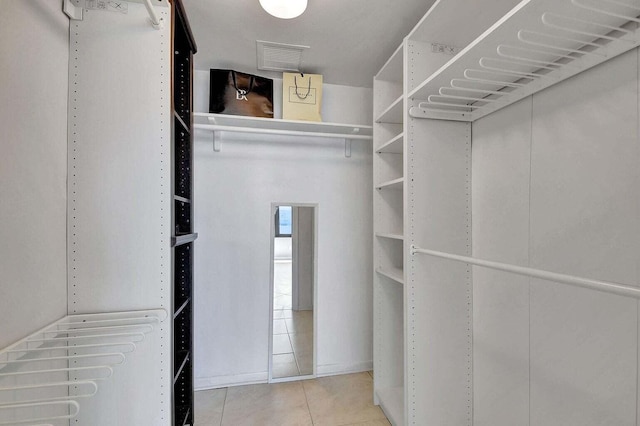 walk in closet featuring tile patterned flooring