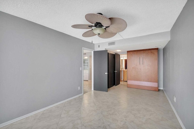 unfurnished bedroom with ceiling fan and light tile patterned floors