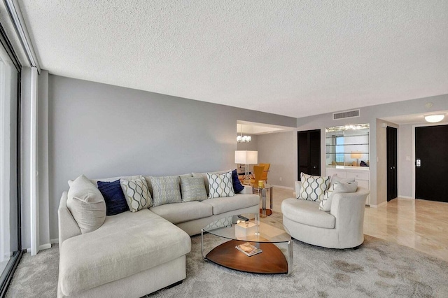 living room featuring a textured ceiling and an inviting chandelier