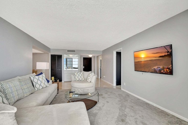 living room featuring carpet floors and a textured ceiling