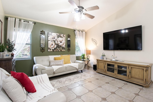 living room with ceiling fan, a wealth of natural light, and vaulted ceiling