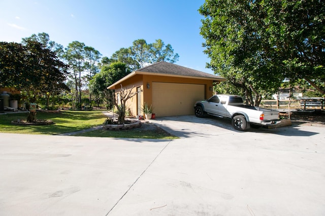 view of side of property with a lawn and a garage