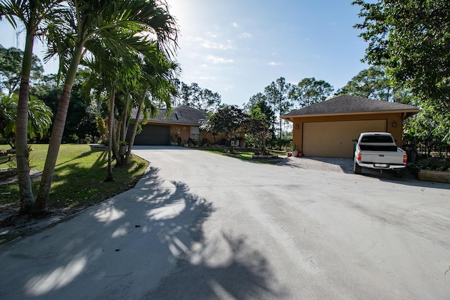 exterior space featuring a lawn and a garage