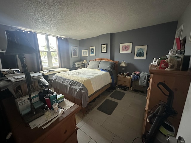 tiled bedroom featuring a textured ceiling