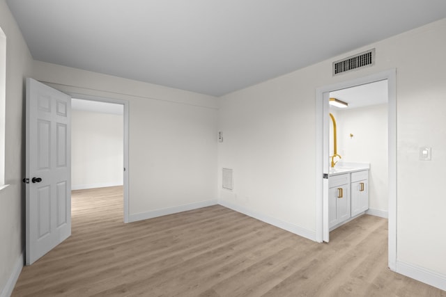 unfurnished room with light wood-type flooring