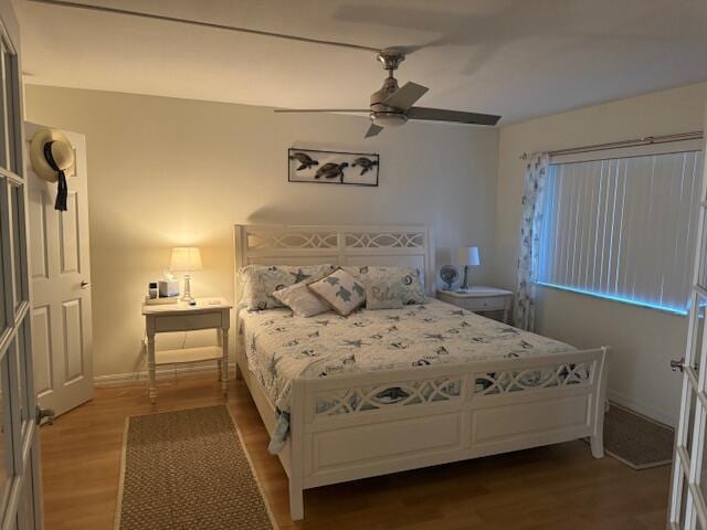 bedroom with hardwood / wood-style floors and ceiling fan