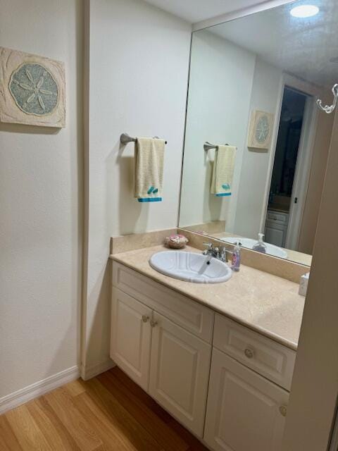 bathroom featuring hardwood / wood-style floors and vanity