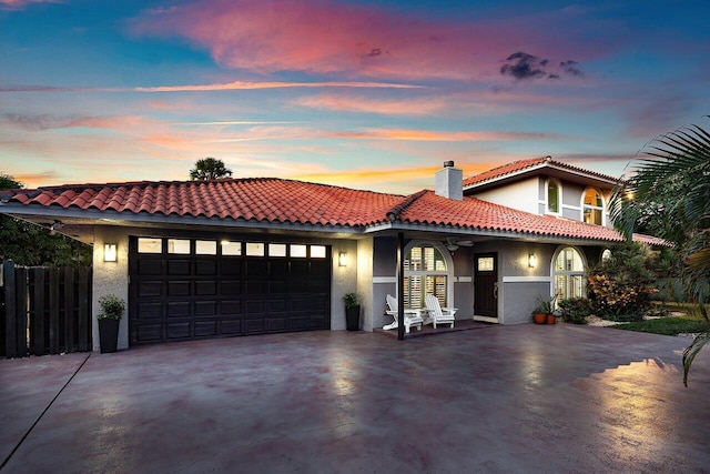 mediterranean / spanish home featuring a garage