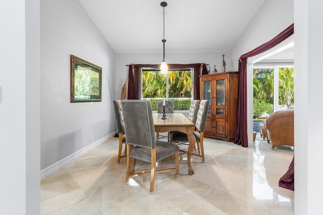 dining space featuring vaulted ceiling