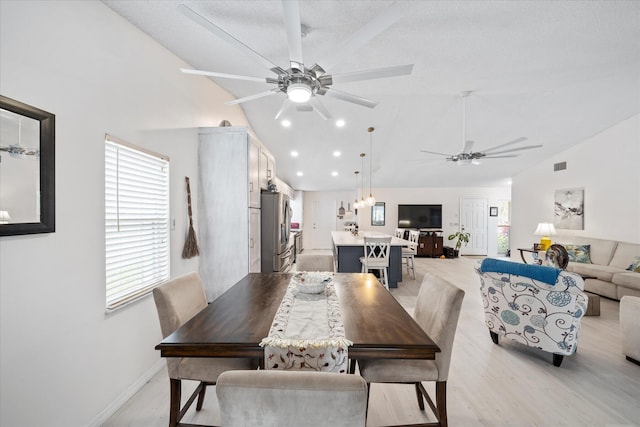 dining room featuring ceiling fan, a textured ceiling, and light wood-type flooring