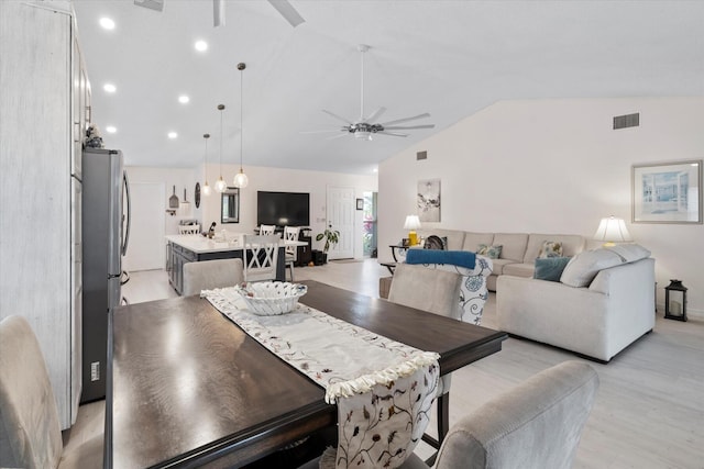 dining area featuring light wood-type flooring, ceiling fan, and lofted ceiling