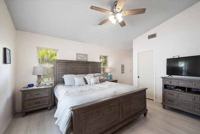 bedroom with ceiling fan, light wood-type flooring, and vaulted ceiling